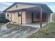 Pink house with carport and stone accents at 6114 S 3Rd St, Tampa, FL 33611