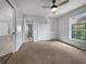 Bright bedroom with neutral carpeting and ceiling fan at 7526 Fairlinks Ct, Sarasota, FL 34243