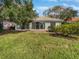 Spacious backyard with grassy area and patio at 7526 Fairlinks Ct, Sarasota, FL 34243