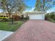 Single story home with brick driveway and landscaping at 7526 Fairlinks Ct, Sarasota, FL 34243