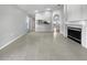 Living room with fireplace, tile floors, and kitchen view at 7526 Fairlinks Ct, Sarasota, FL 34243