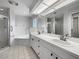 Updated bathroom with double vanity, soaking tub, and shower at 7526 Fairlinks Ct, Sarasota, FL 34243