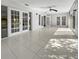 Bright sunroom with tile floors and multiple glass doors at 7526 Fairlinks Ct, Sarasota, FL 34243