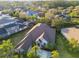 Aerial view of a single-Gathering home with lush landscaping, a long driveway, and a neutral color palette exterior at 11909 Mandevilla Ct, Tampa, FL 33626