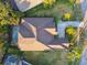 Overhead view of property with an enclosed pool, green lawn and a long driveway at 11909 Mandevilla Ct, Tampa, FL 33626