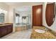 Bright bathroom featuring a soaking tub, granite counters and a glass-enclosed shower at 11909 Mandevilla Ct, Tampa, FL 33626