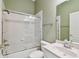 Well-lit bathroom featuring a shower-tub combo and a single-sink vanity at 11909 Mandevilla Ct, Tampa, FL 33626