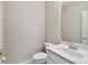 This bathroom features a toilet, a sink with mirror, and a clean, neutral color scheme at 11909 Mandevilla Ct, Tampa, FL 33626