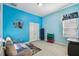 Bright blue bedroom with modern decor and a cozy seating area at 11909 Mandevilla Ct, Tampa, FL 33626