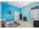 Cheerful bedroom with a blue accent wall, light flooring and decorative Star Wars wall graphics at 11909 Mandevilla Ct, Tampa, FL 33626