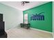 Bedroom with a ceiling fan and a unique swimmer graphic wall decoration at 11909 Mandevilla Ct, Tampa, FL 33626