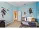 Stylish bedroom with a comfortable daybed, light flooring and Star Wars character wall graphics at 11909 Mandevilla Ct, Tampa, FL 33626