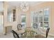 Bright breakfast nook features a modern chandelier, outdoor view, and access to the outdoor pool area at 11909 Mandevilla Ct, Tampa, FL 33626