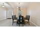 Formal dining room featuring tile floors, modern lighting, and a neutral color palette at 11909 Mandevilla Ct, Tampa, FL 33626