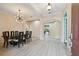 Open dining area with modern light fixture and a glimpse into the living room at 11909 Mandevilla Ct, Tampa, FL 33626