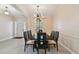 Elegant dining room featuring modern chandelier, and seating for eight, with a large window at 11909 Mandevilla Ct, Tampa, FL 33626