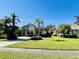 Beautiful single-Gathering home with mature landscaping, a long driveway and stone accents for enhanced curb appeal at 11909 Mandevilla Ct, Tampa, FL 33626