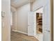 Hallway features a view to a storage closet with shelves and a glimpse of the home's security system at 11909 Mandevilla Ct, Tampa, FL 33626