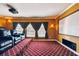 Home theater room complete with tiered seating, projector, screen, sconce lighting, and window with draped curtains at 11909 Mandevilla Ct, Tampa, FL 33626