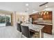 Gourmet kitchen with granite counters, stainless appliances, custom cabinetry, and breakfast bar seating area at 11909 Mandevilla Ct, Tampa, FL 33626