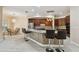 Modern kitchen featuring a center island with barstool seating, stainless steel appliances, and modern lighting fixtures at 11909 Mandevilla Ct, Tampa, FL 33626