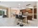 Open kitchen features bar seating at the island with a view into the dining area at 11909 Mandevilla Ct, Tampa, FL 33626