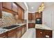 Well-equipped kitchen showcasing granite counters, tile backsplash, stainless appliances, and center island at 11909 Mandevilla Ct, Tampa, FL 33626