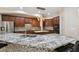 Spacious kitchen featuring granite counters, stainless steel appliances, tile backsplash, and dark wood cabinetry at 11909 Mandevilla Ct, Tampa, FL 33626