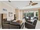 Bright and airy living room offering a view of the pool area and plenty of comfortable seating at 11909 Mandevilla Ct, Tampa, FL 33626