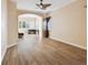 Bright living room with hardwood floors and a window providing lots of natural light at 11909 Mandevilla Ct, Tampa, FL 33626