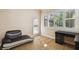 Comfortable living room with desk, shutters, and a doorway leading outside at 11909 Mandevilla Ct, Tampa, FL 33626