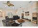Comfortable living room with plenty of natural light and a ceiling fan that provides a view of other rooms at 11909 Mandevilla Ct, Tampa, FL 33626