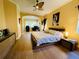 Large main bedroom with hardwood floors and a ceiling fan offering a comfortable and private retreat at 11909 Mandevilla Ct, Tampa, FL 33626