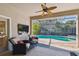 Screened patio with seating around table and outdoor lounge area beside the pool at 11909 Mandevilla Ct, Tampa, FL 33626