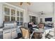 Covered patio with grill, fire pit, seating, and an adjacent door leading indoors at 11909 Mandevilla Ct, Tampa, FL 33626