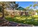 Neighborhood playground featuring a green canopy, slides, climbing structures, and artificial turf at 11909 Mandevilla Ct, Tampa, FL 33626