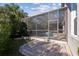 Screened-in pool area with brick-paved patio, perfect for outdoor entertaining and relaxation at 11909 Mandevilla Ct, Tampa, FL 33626