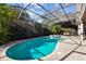 Sparkling screened pool with spa and brick paved patio area, great for enjoying the outdoors at 11909 Mandevilla Ct, Tampa, FL 33626