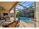 Enjoy the outdoors on this screened patio with in-ground pool and relaxing hot tub at 11909 Mandevilla Ct, Tampa, FL 33626
