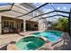 This home features a beautiful in-ground pool, hot tub, and a spacious screened patio at 11909 Mandevilla Ct, Tampa, FL 33626