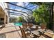 A beautiful backyard featuring a covered patio, pool, spa, and outdoor furniture at 11909 Mandevilla Ct, Tampa, FL 33626