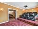 Home theater features tiered seating and a game room with pool table is visible through doorway at 11909 Mandevilla Ct, Tampa, FL 33626