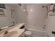 Bright bathroom features a bathtub and shower combination, toilet, and large mirror over a light countertop sink at 642 Bird Bay E Dr # 205, Venice, FL 34285