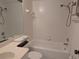 Bathroom featuring white tile, tub, toilet, and vanity with sink at 642 Bird Bay E Dr # 205, Venice, FL 34285