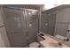 Bathroom showcasing a frosted glass shower door, a toilet, and a single sink with a vanity mirror at 642 Bird Bay E Dr # 205, Venice, FL 34285