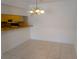 Bright dining area with tile flooring, an elegant chandelier, and a breakfast bar for casual meals at 642 Bird Bay E Dr # 205, Venice, FL 34285