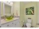 Powder room with pedestal sink, toilet, and framed art at 2521 W Marion Ave # 412, Punta Gorda, FL 33950