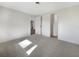 Bright bedroom with gray carpeting and a view of the backyard at 290 Dragon Rd, Venice, FL 34293