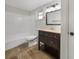 Updated bathroom with dark vanity, tile flooring and a bathtub at 290 Dragon Rd, Venice, FL 34293