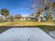 Large backyard with grassy area and a concrete patio at 290 Dragon Rd, Venice, FL 34293